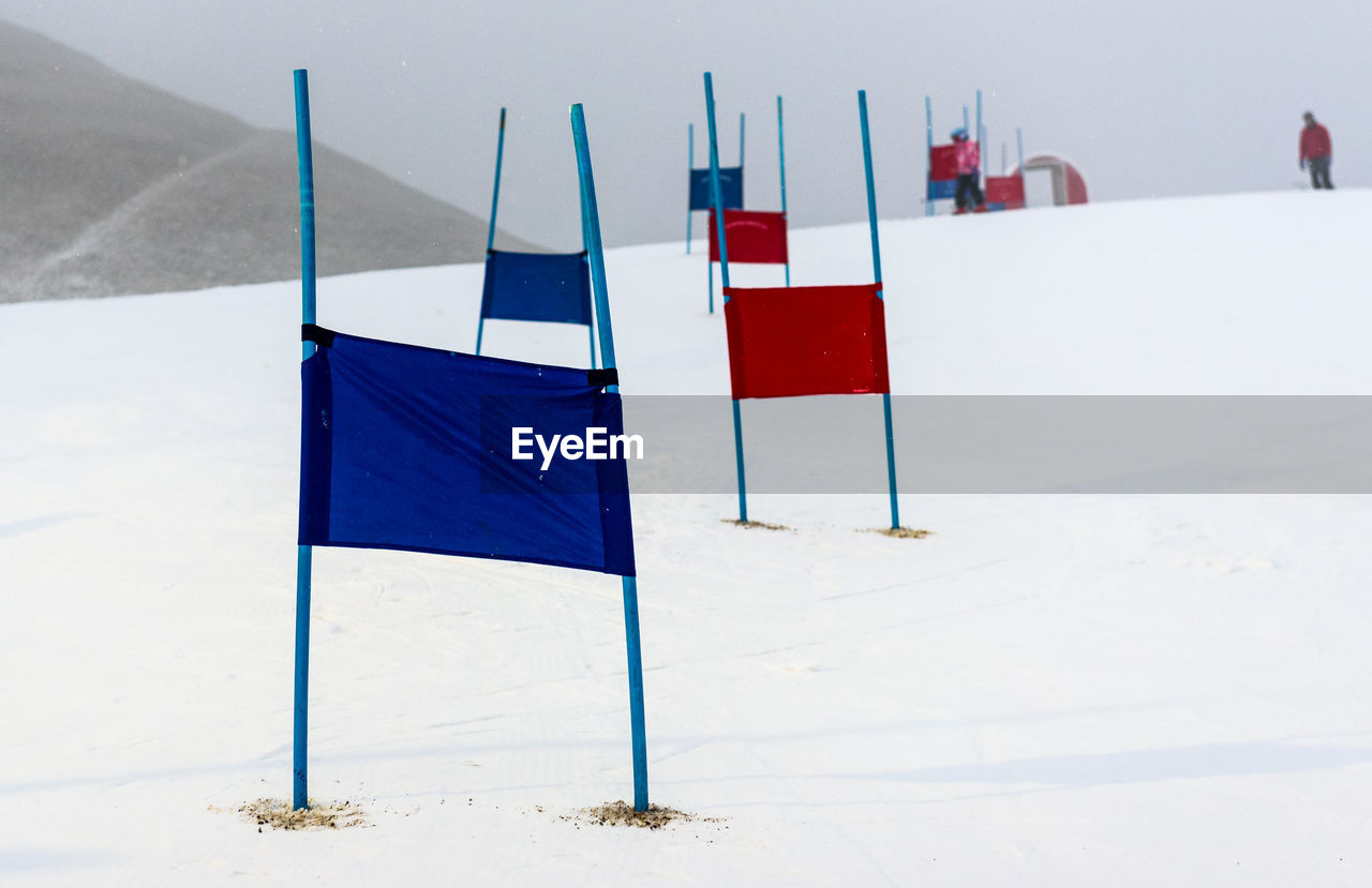 WHITE FLAGS ON BEACH AGAINST SKY