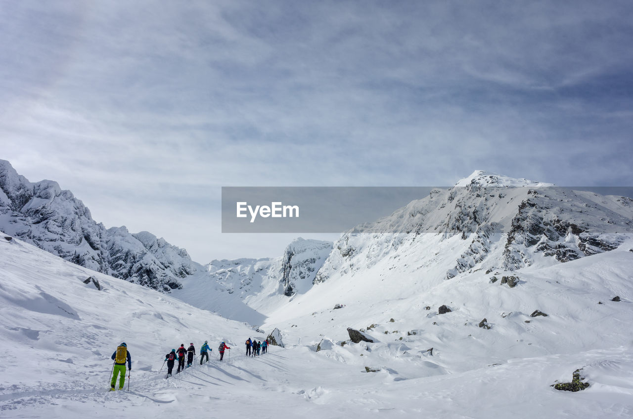 People climbing on snowcapped mountains