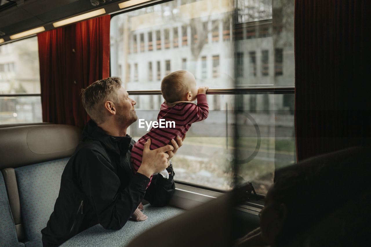 Father traveling with baby by train