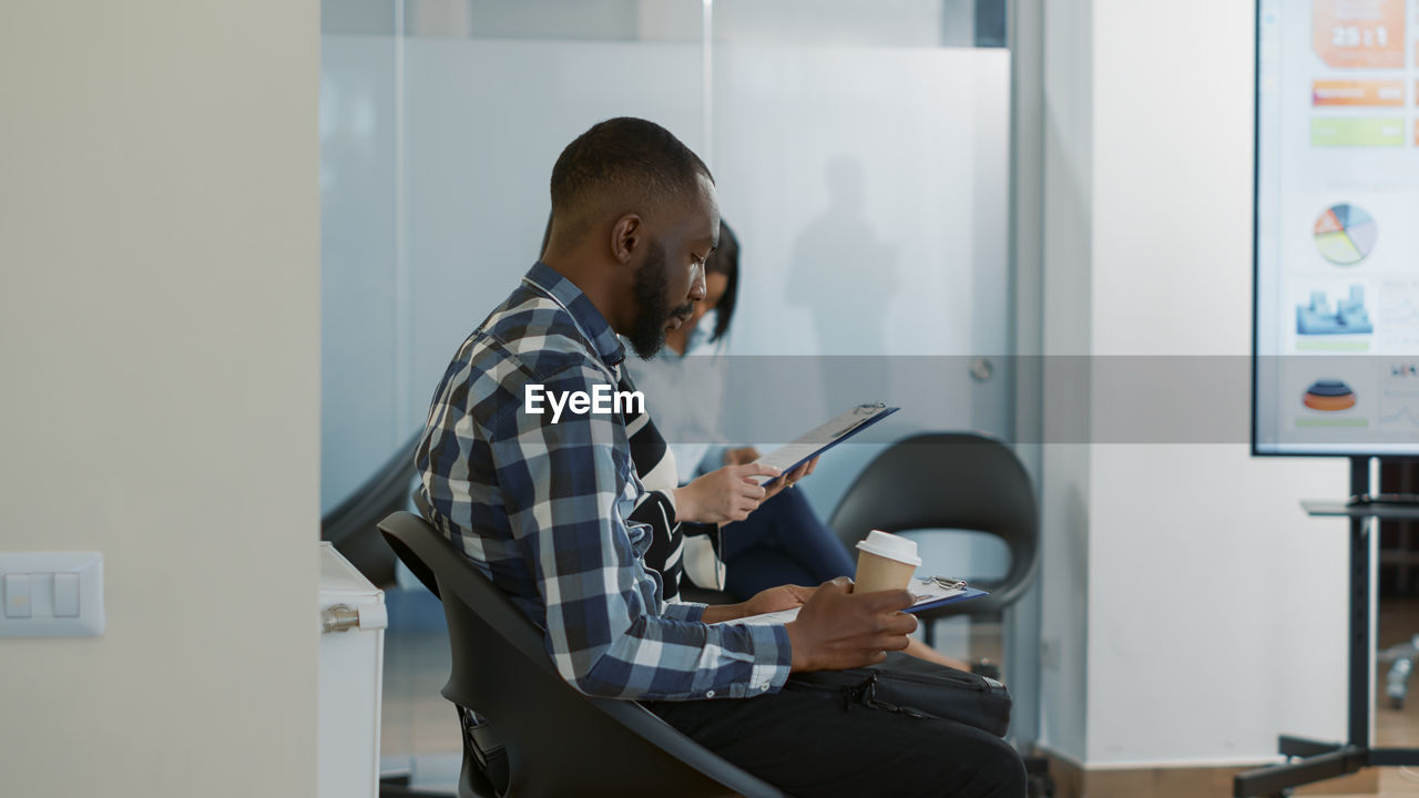 Side view of man working at office