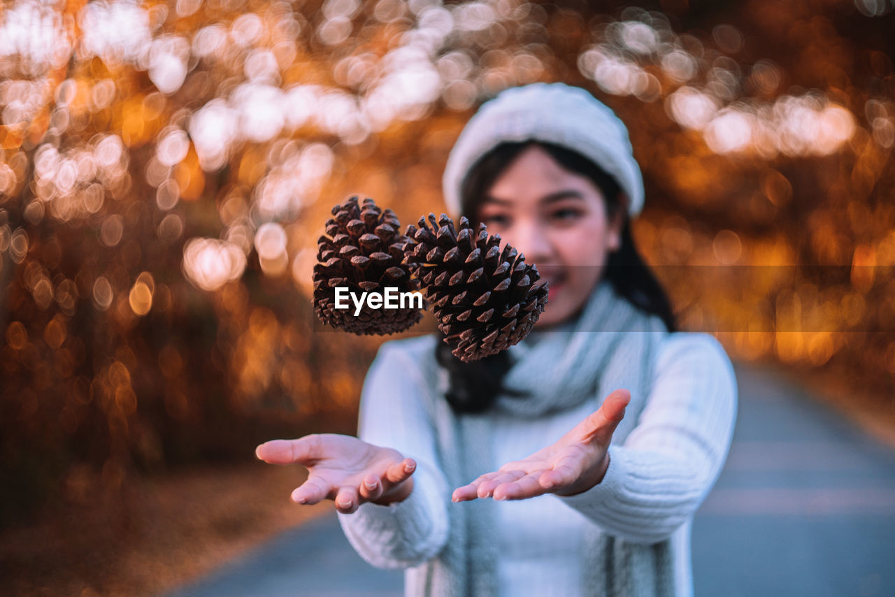 Woman catching pine cones