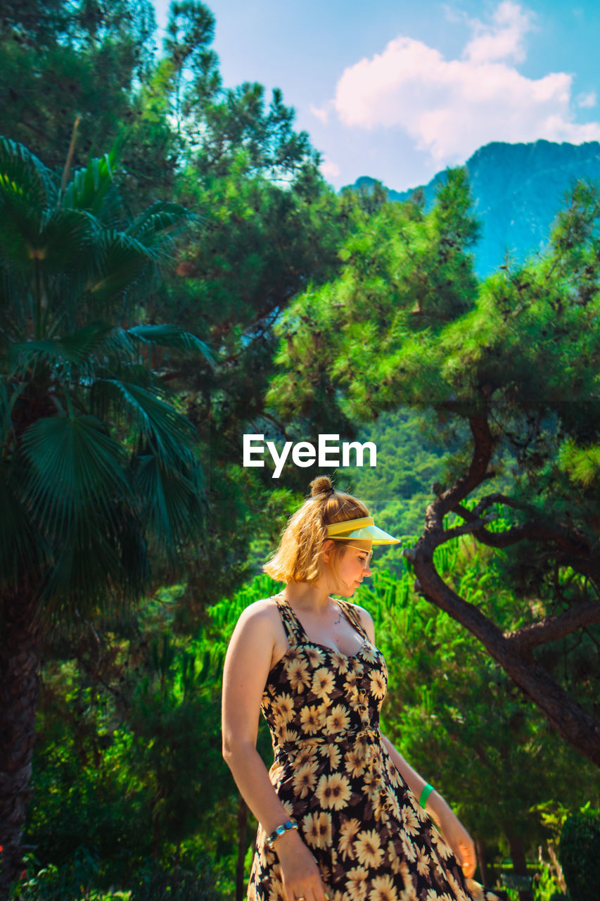 Woman standing against tree