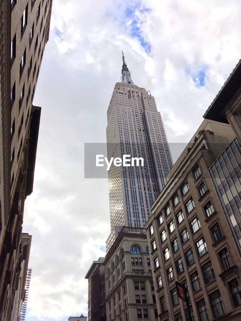 Low angle view of buildings against cloudy sky