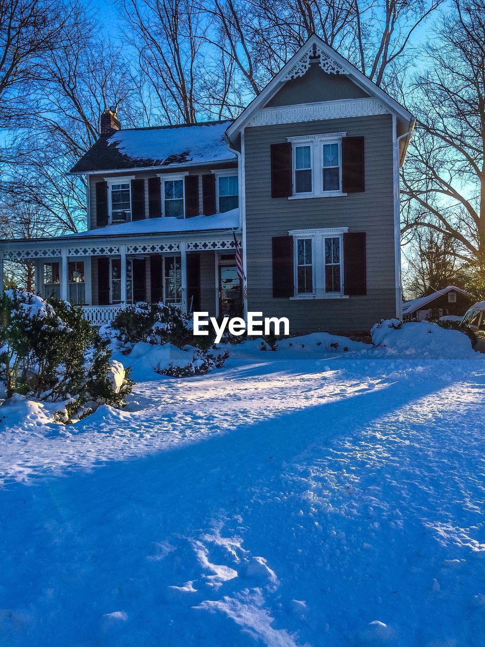 View of snow covered house and yard