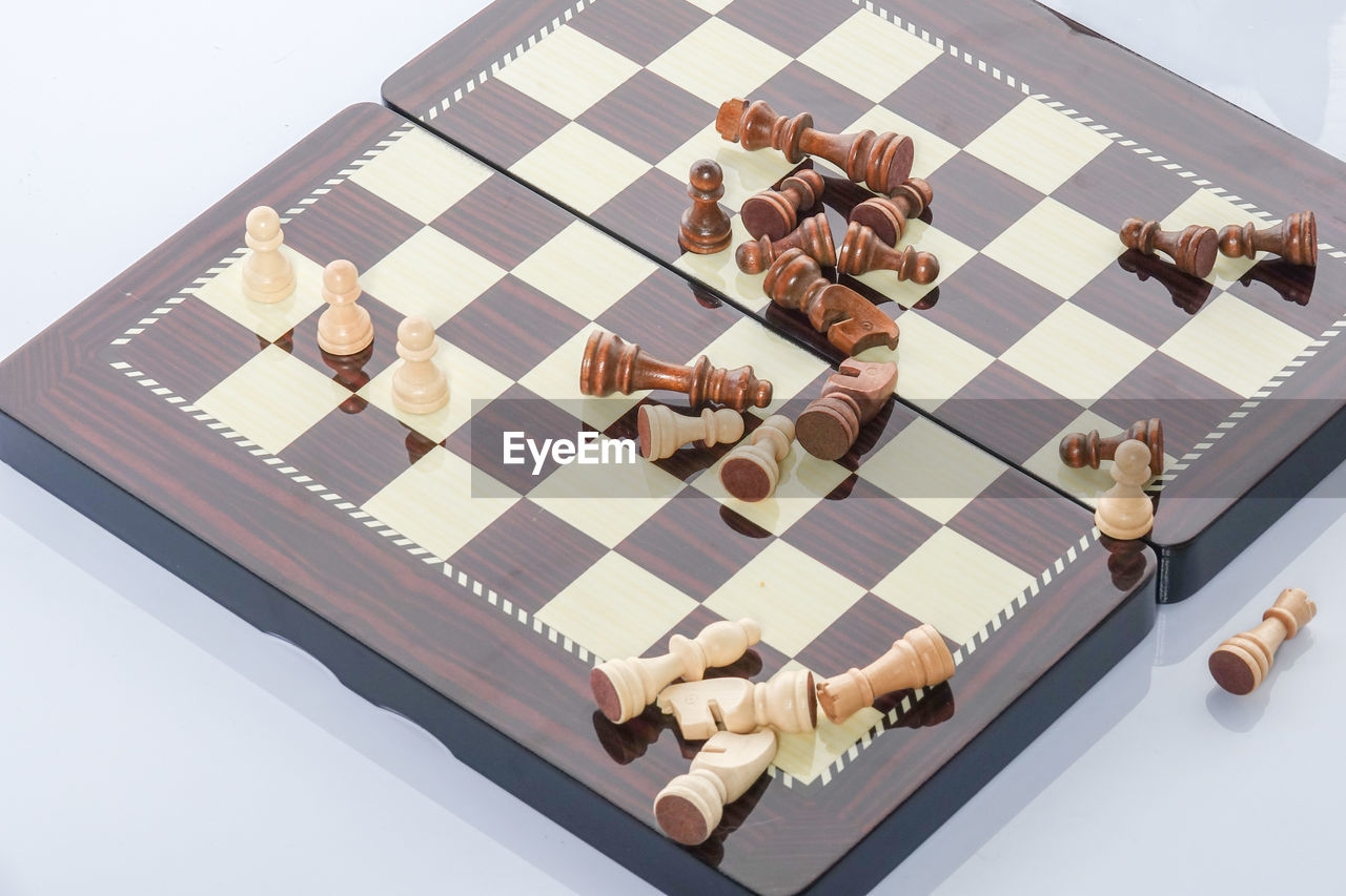 High angle view of chess board over white background