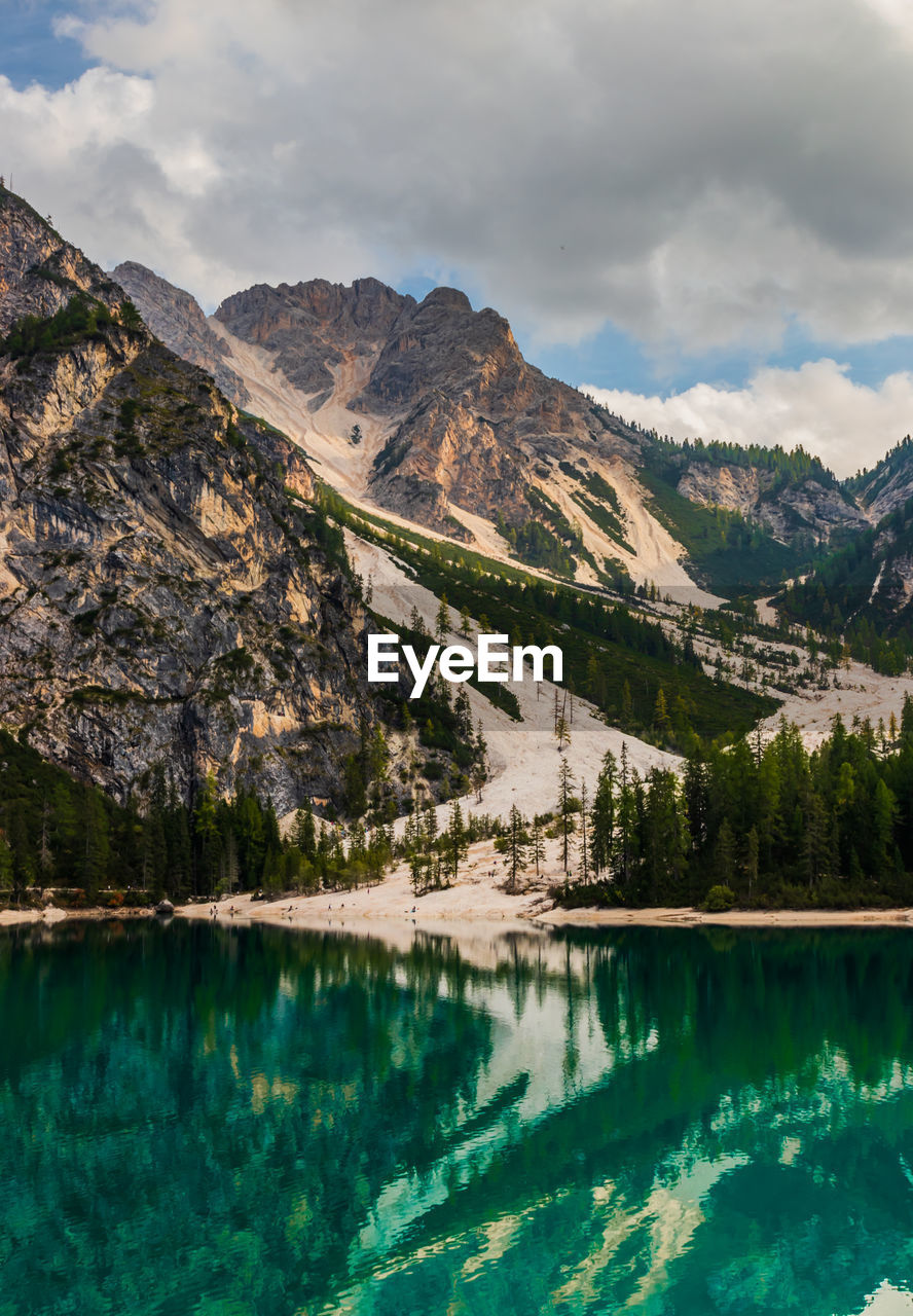 Scenic view of lake by mountains against sky