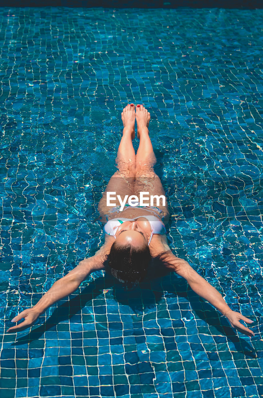 Woman in bikini at swimming pool