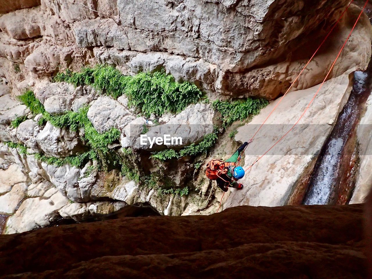 High angle view of man climbing on rock