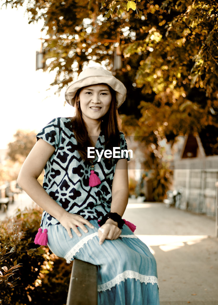 Portrait of smiling young woman in park