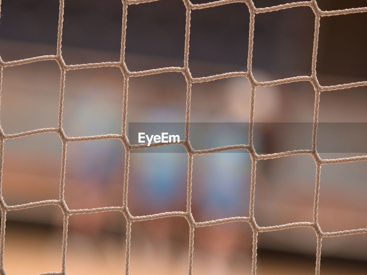 Tournament view through the protective net of futsal match. visitor view from vip chair.