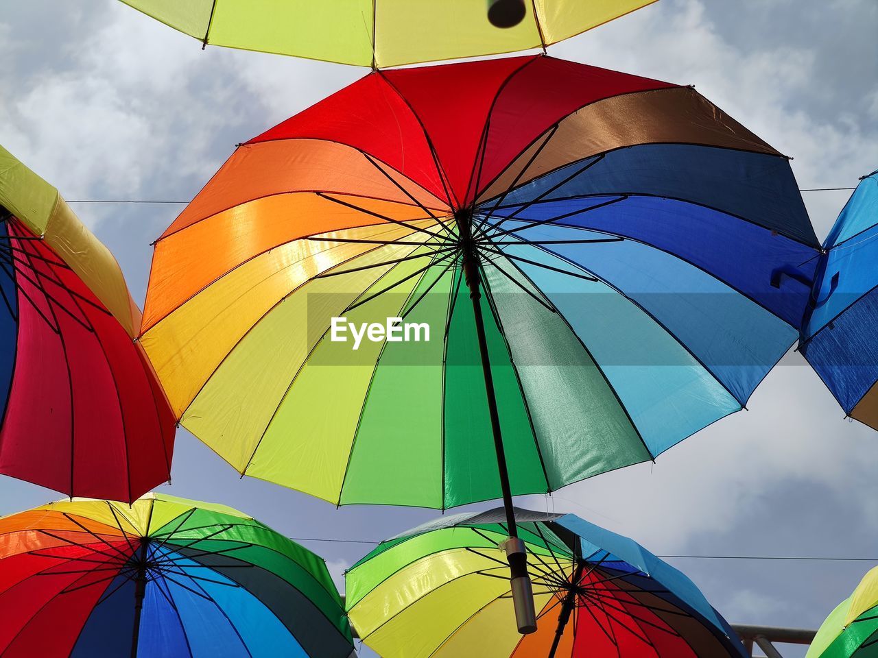 Low angle view of umbrellas against sky