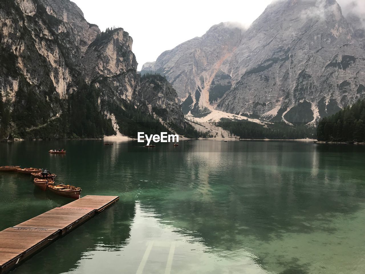 Scenic view of lake by mountains against sky