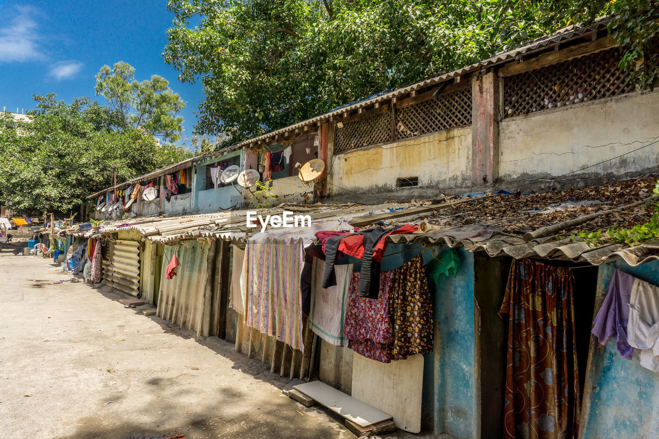 CLOTHES DRYING AGAINST WALL AT MARKET STALL