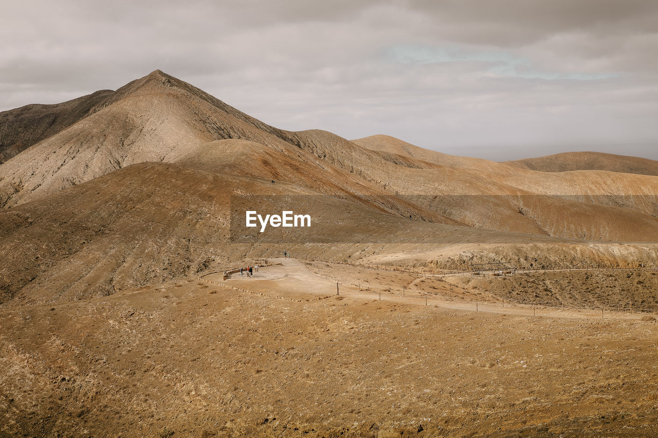 Scenic view of arid mountain landscape against sky