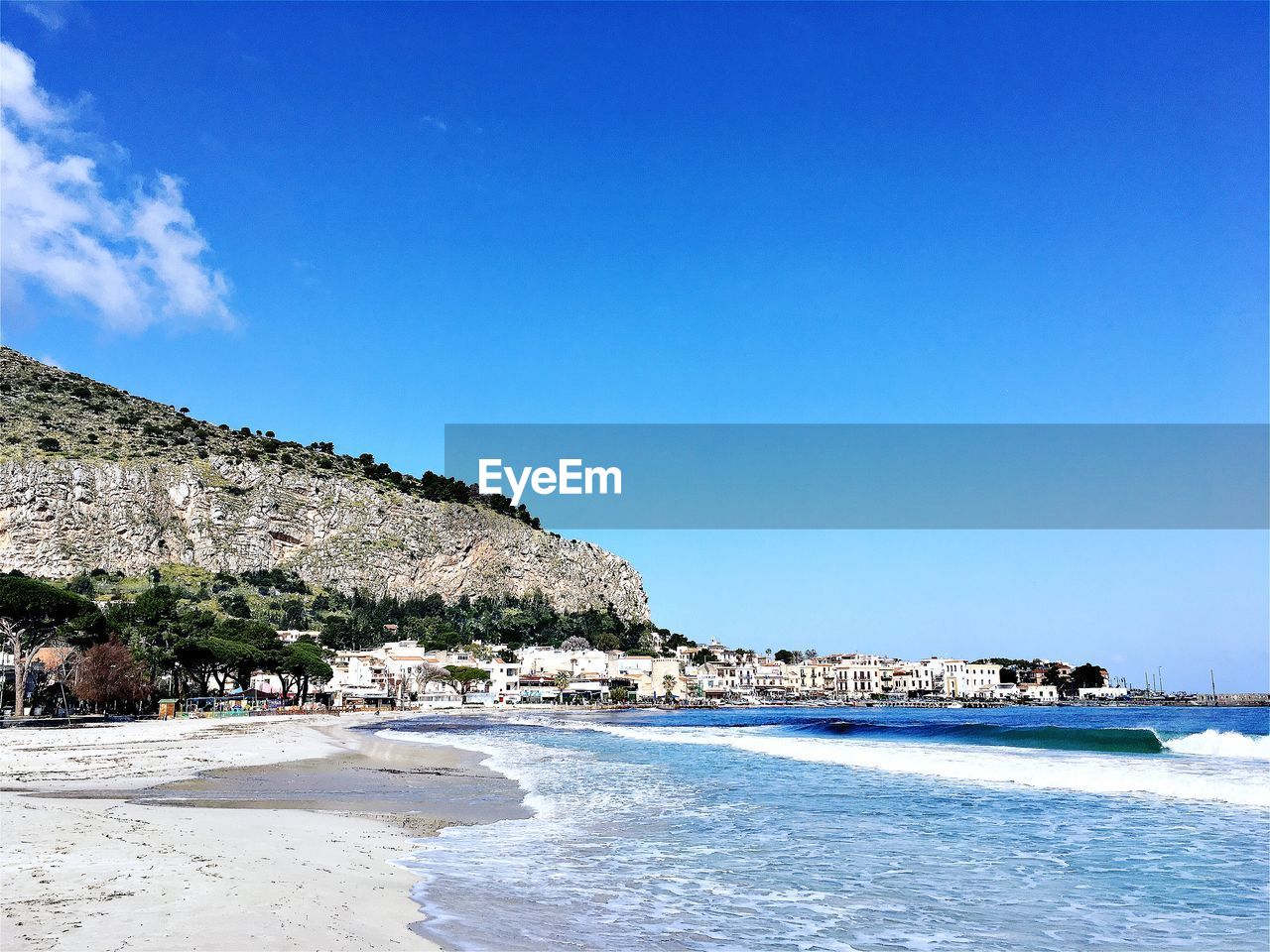 Scenic view of beach against blue sky