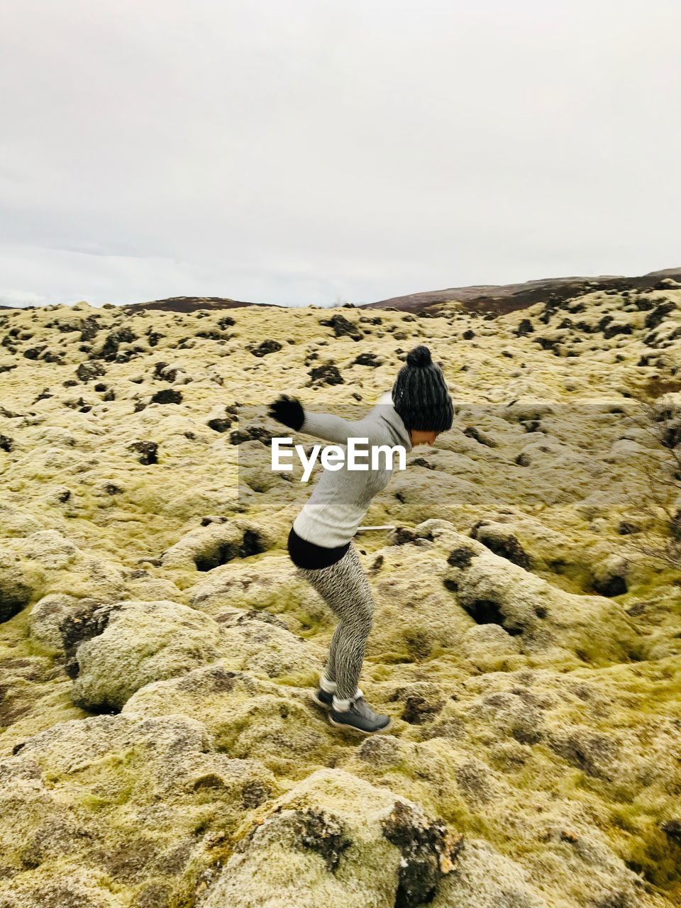 Side view of woman jumping outdoors