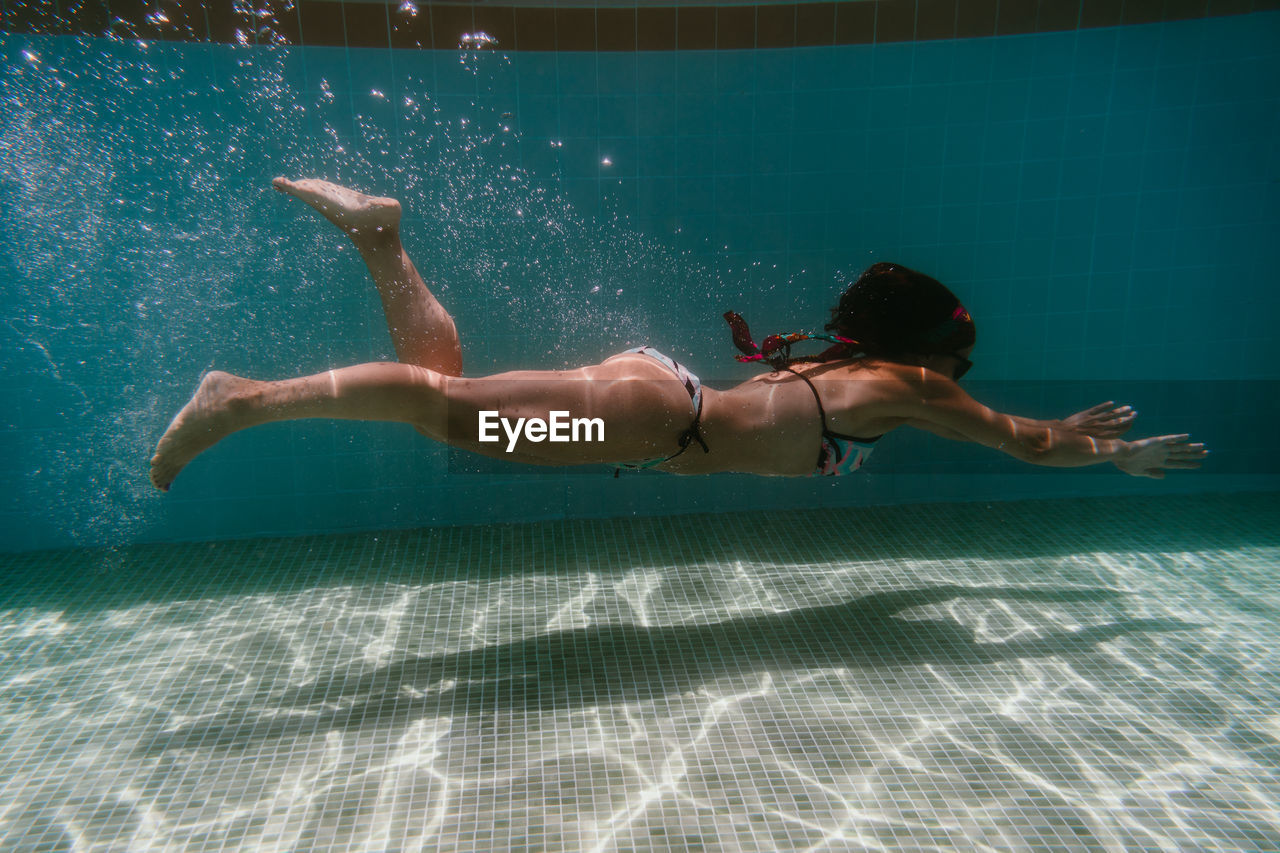 Full length of woman swimming in pool