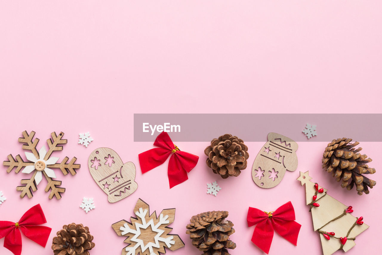 high angle view of christmas decorations on pink background