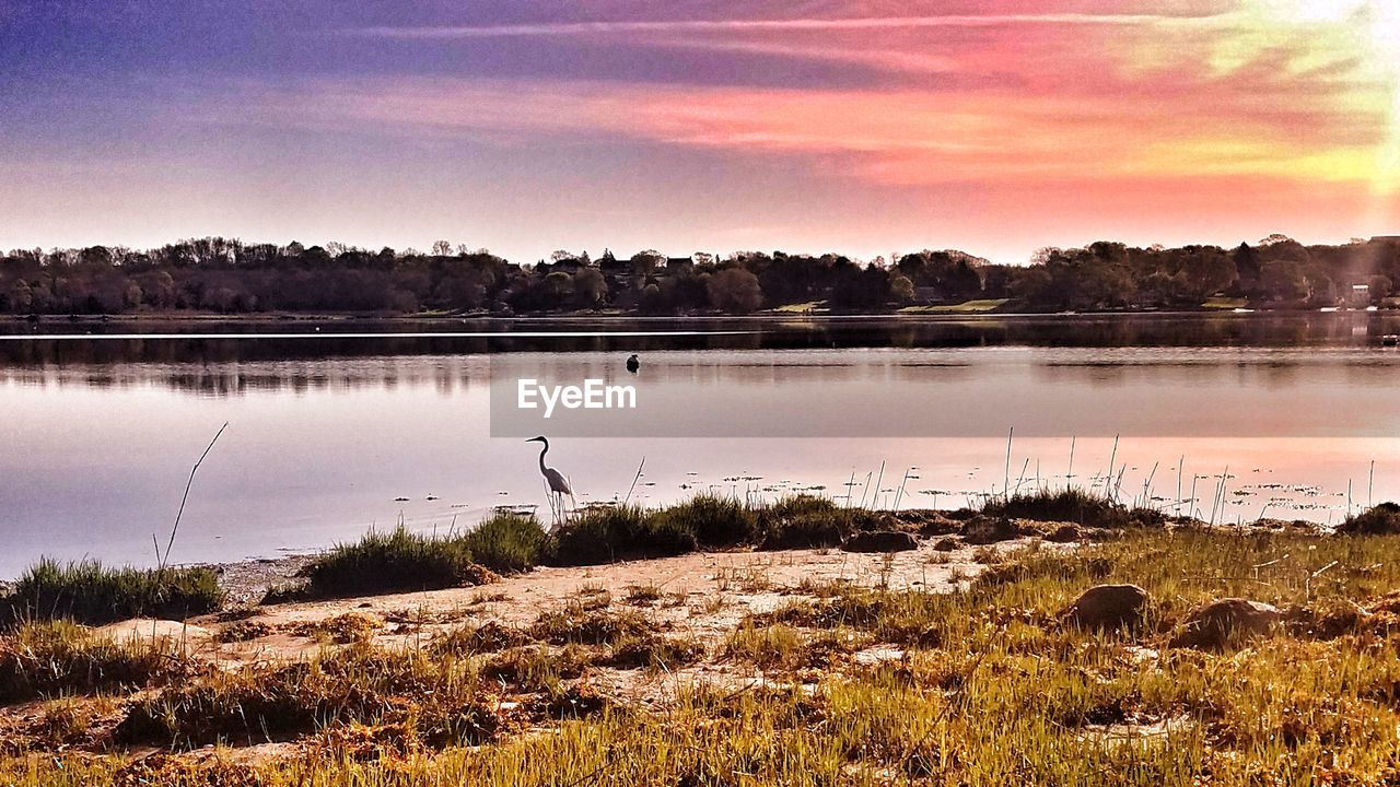 SCENIC VIEW OF LAKE AGAINST SKY DURING SUNSET