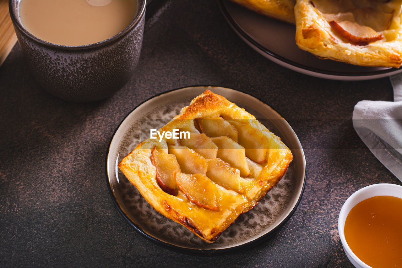 Small upside down puff pastry cake with apple on a plate