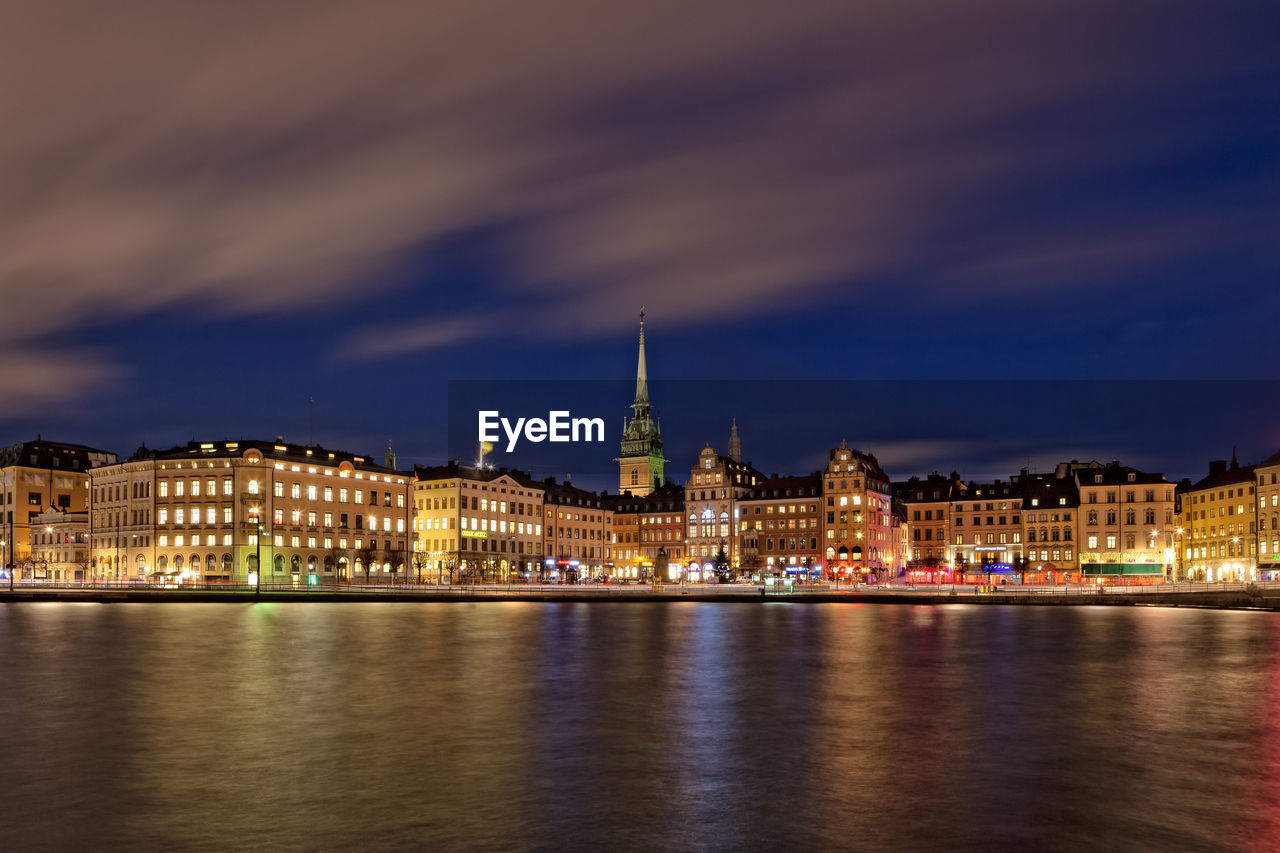 View of buildings at waterfront during night