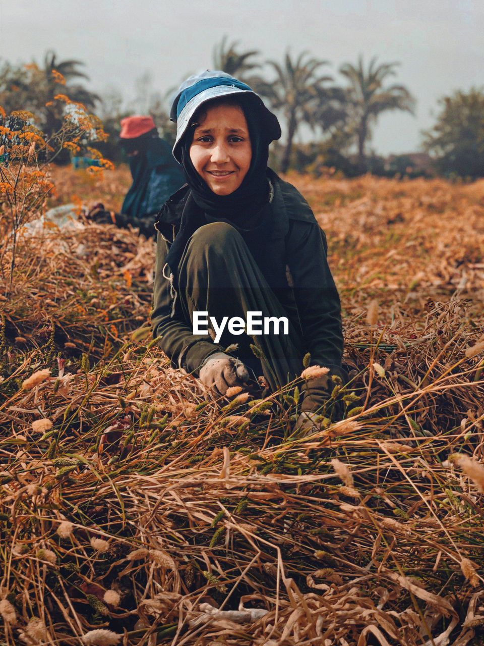 PORTRAIT OF SMILING BOY ON FIELD