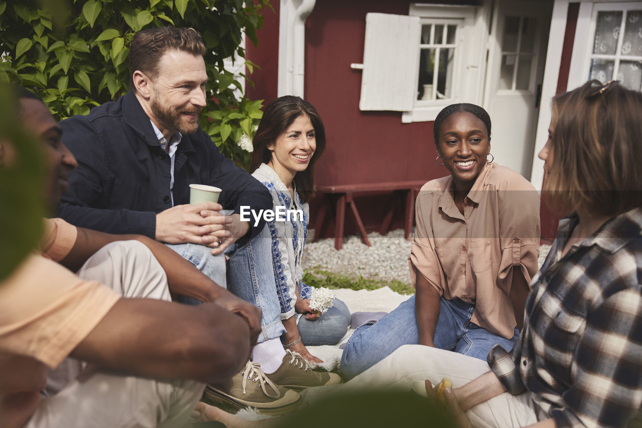 Friends sitting together in garden