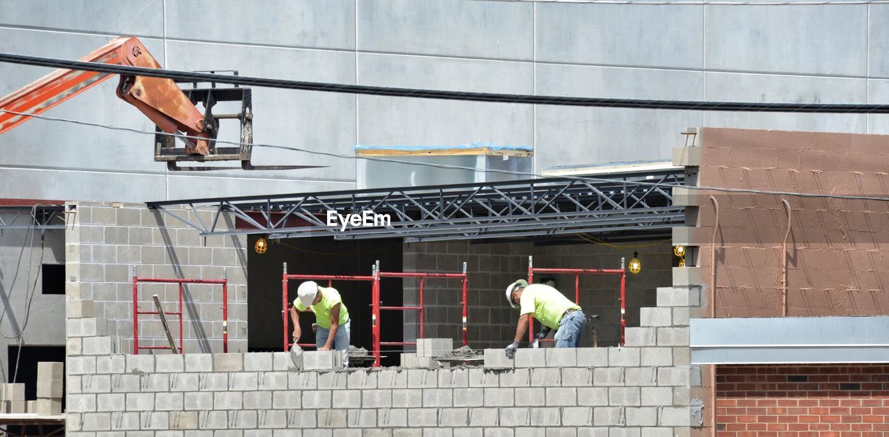 MEN WORKING AT CONSTRUCTION SITE