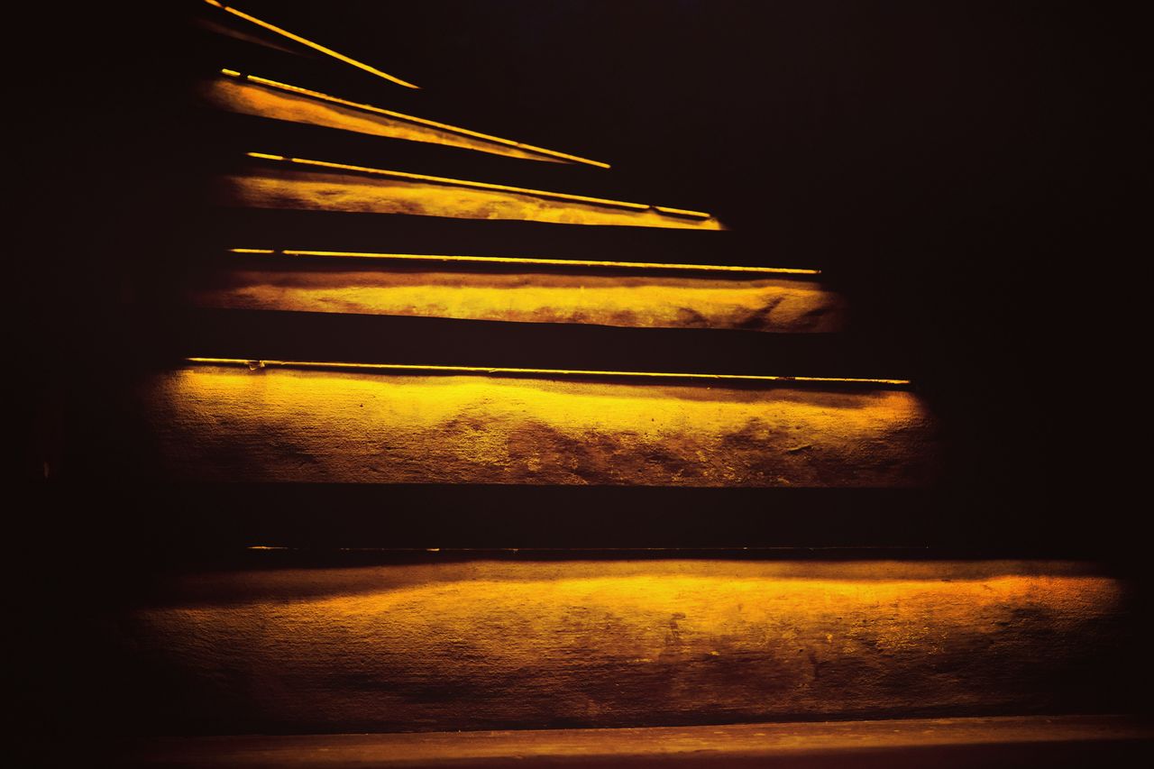 Illuminated golden stairs at night