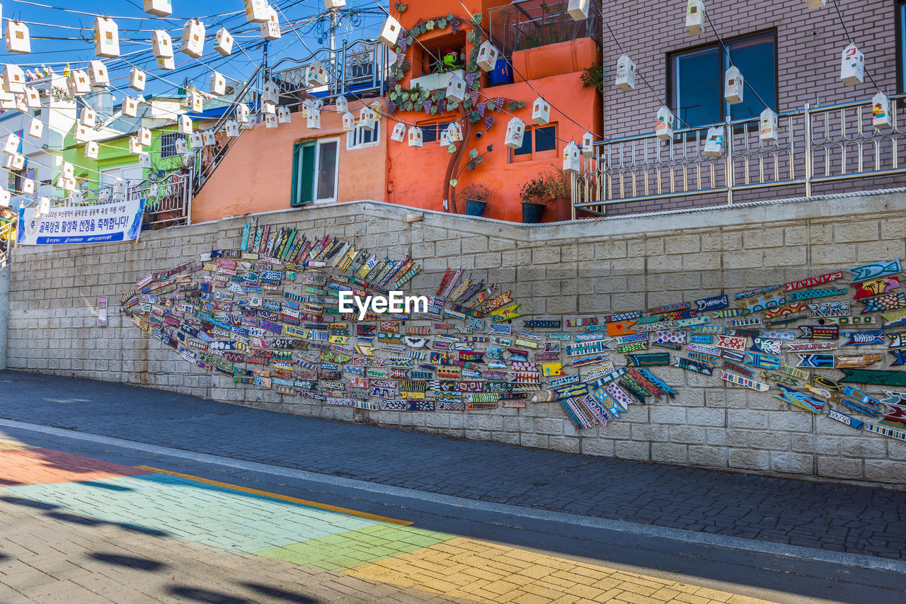 architecture, built structure, urban area, building exterior, city, multi colored, transportation, building, street, no people, day, outdoors, travel destinations, nature, travel, sport venue, road