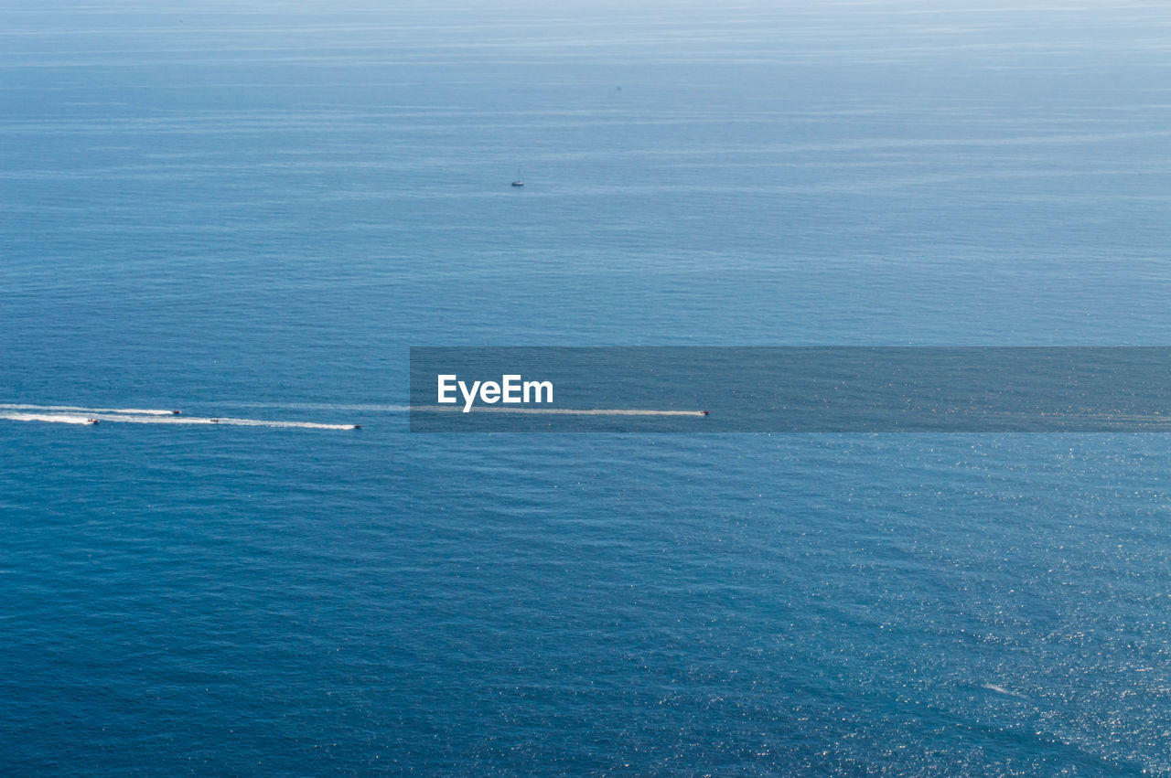 Full frame shot of boats racing in blue sea