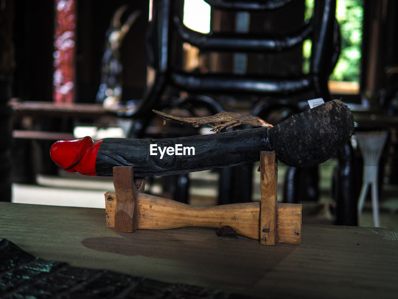 CLOSE-UP OF BLACK SHOES HANGING ON WOODEN TABLE