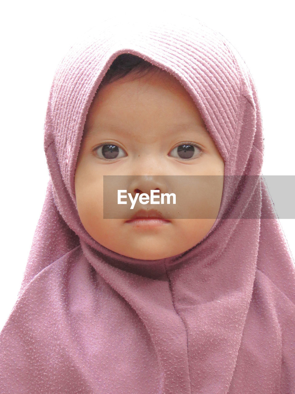 Close-up portrait of innocent girl against white background 