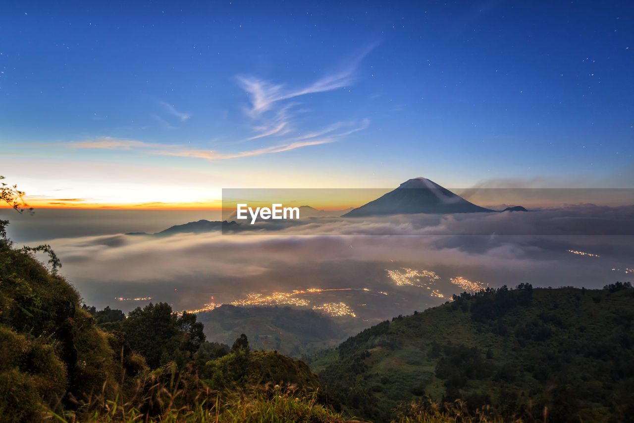 Scenic view of mountains against sky at sunset