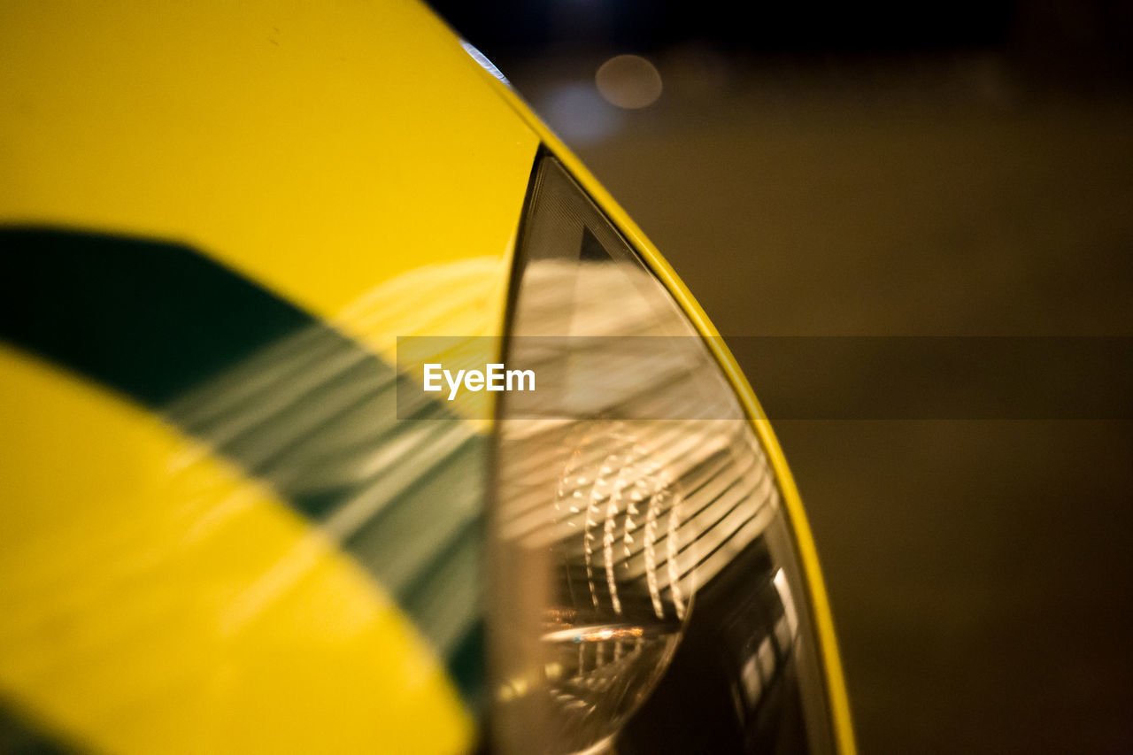 CLOSE-UP OF YELLOW LEAF ON METAL STRUCTURE