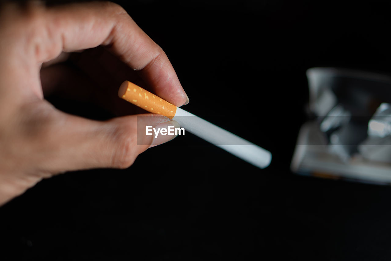 cropped hand of person holding thermometer