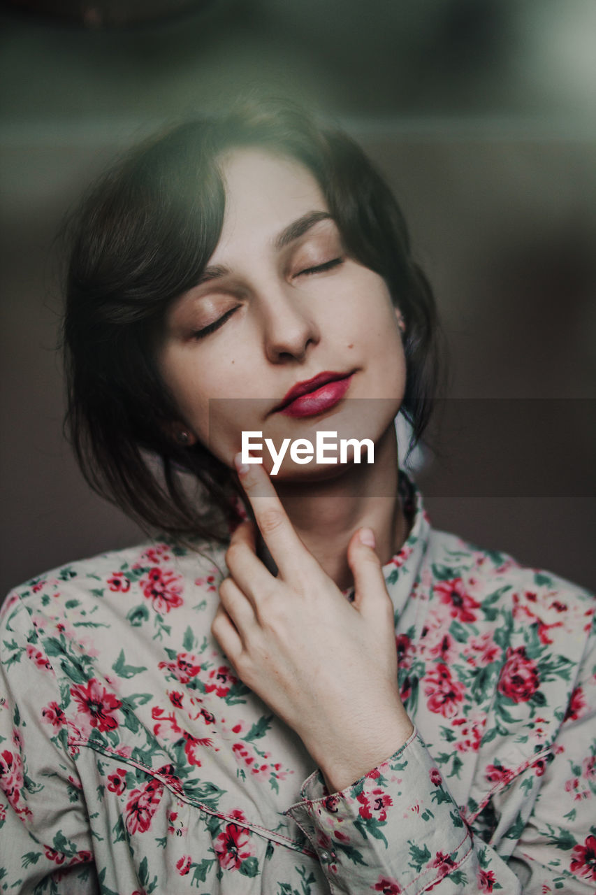 Portrait of beautiful young woman with eyes closed