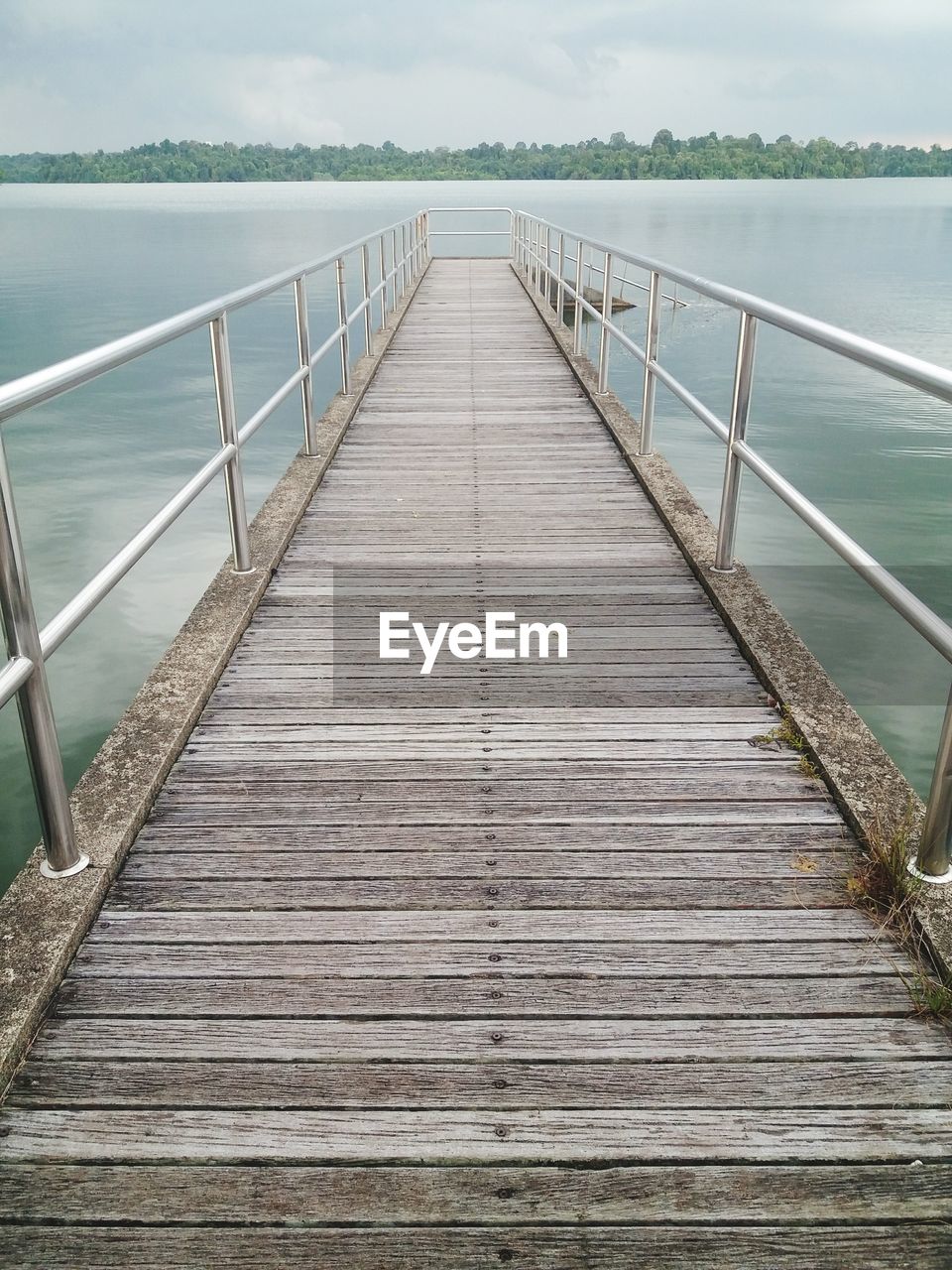 WOODEN FOOTBRIDGE ON PIER OVER SEA