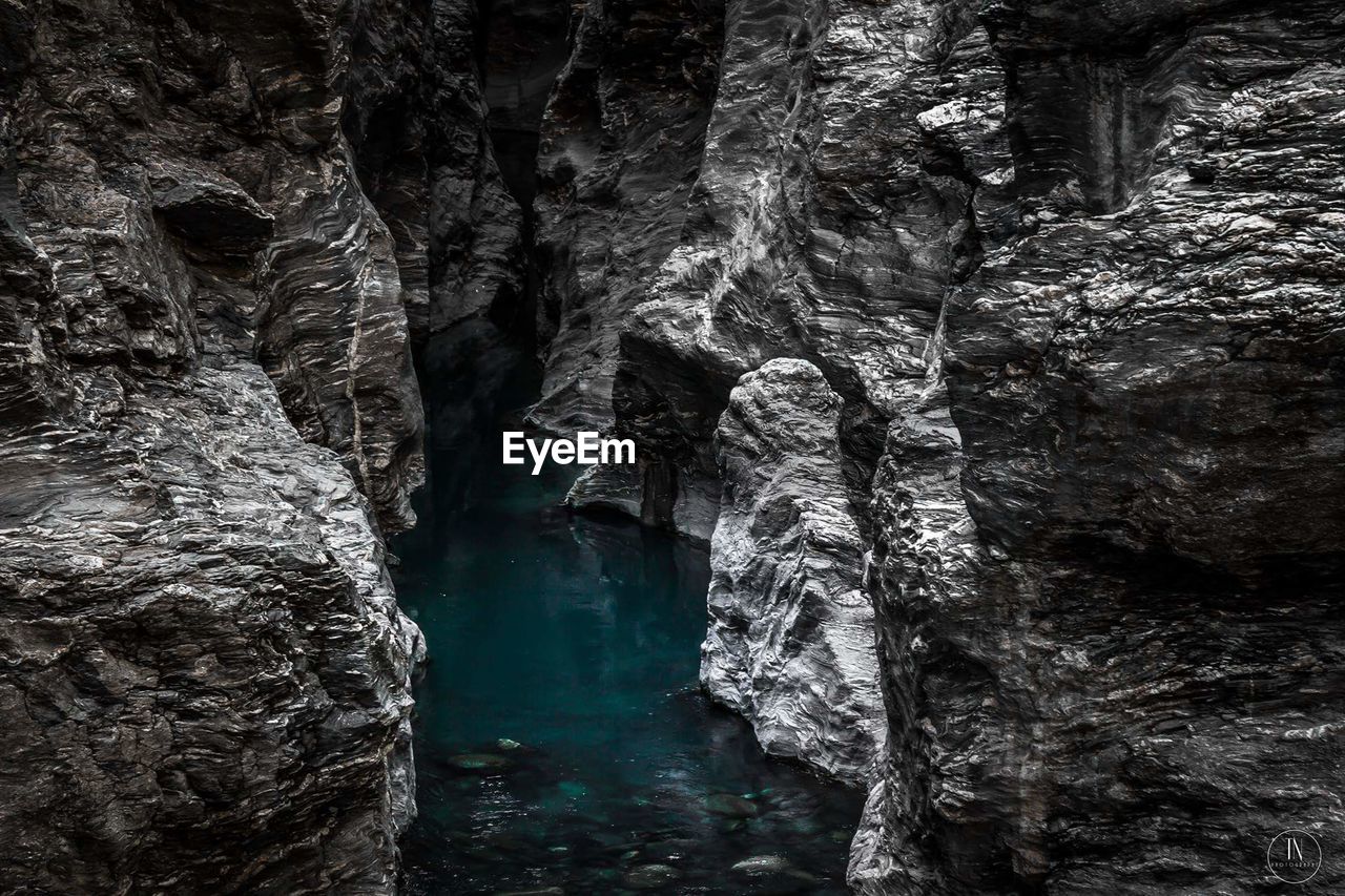 SCENIC VIEW OF CAVE AND WATERFALL