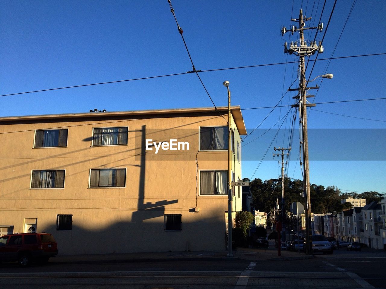 Street by building against clear blue sky