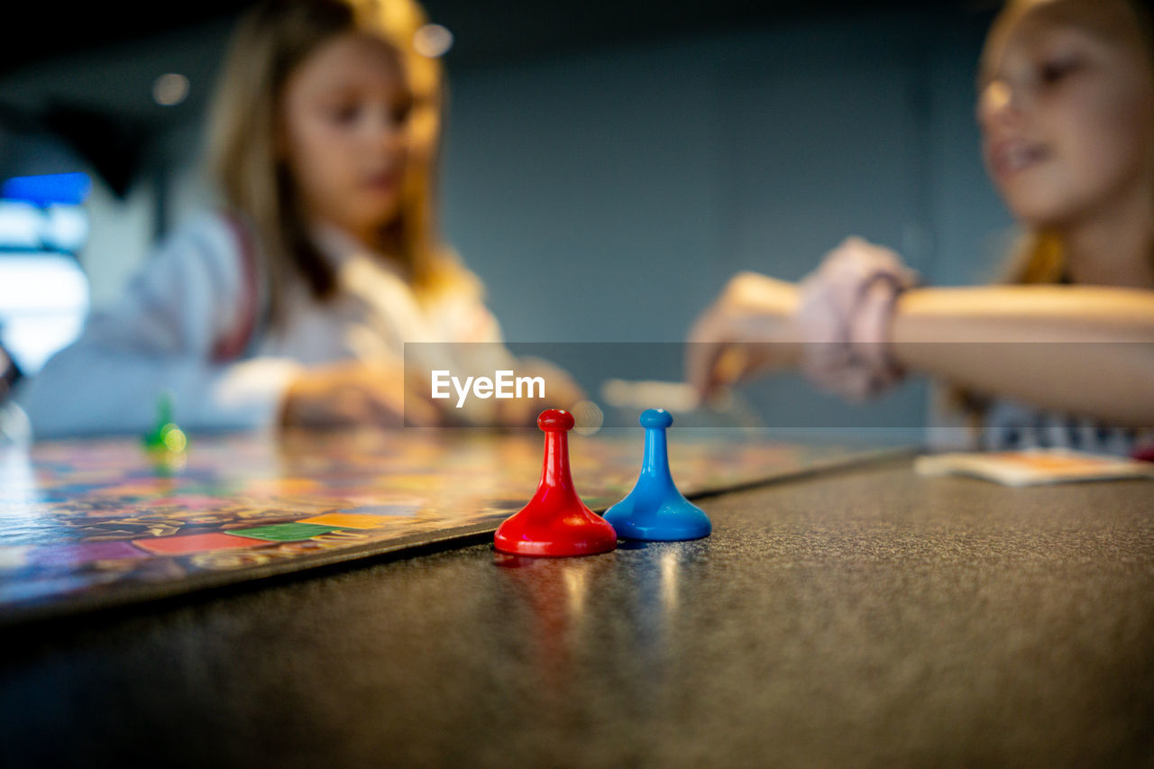 Close-up of people playing board game on table