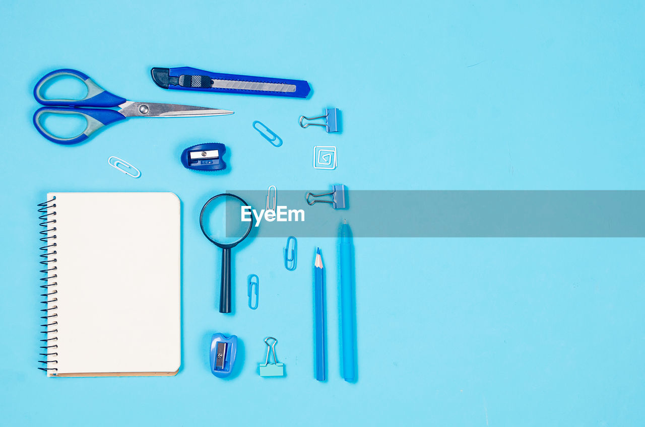 blue, blue background, scissors, colored background, indoors, studio shot, no people, clip, paper clip, copy space, office supply, healthcare and medicine, still life, font, directly above, knolling - concept