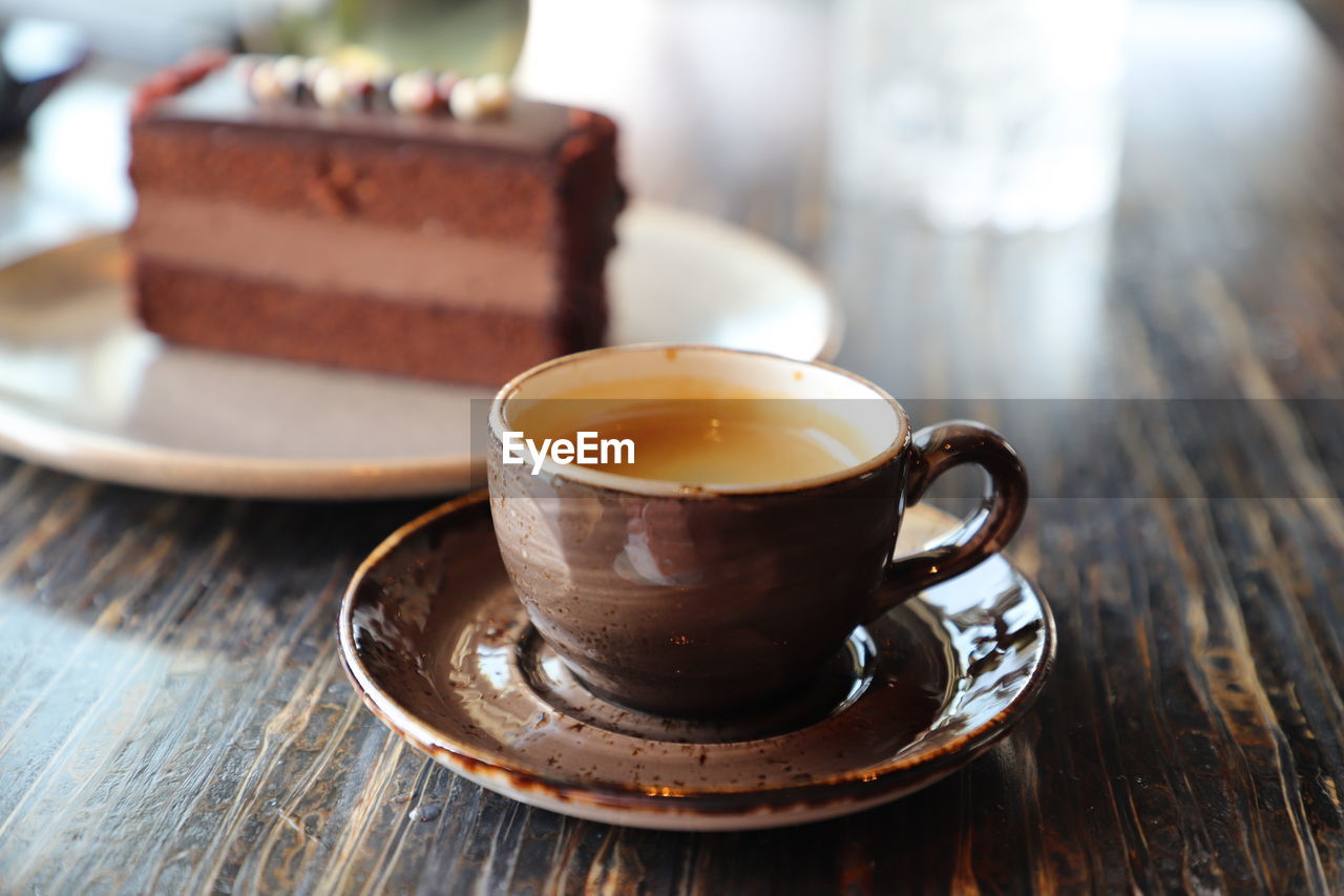 food and drink, drink, mug, cup, hot drink, refreshment, crockery, table, wood, coffee, food, tea, saucer, tea cup, coffee cup, cafe, sweet food, sweet, freshness, indoors, no people, dessert, close-up, focus on foreground, baked, coffee break, turkish coffee, cake