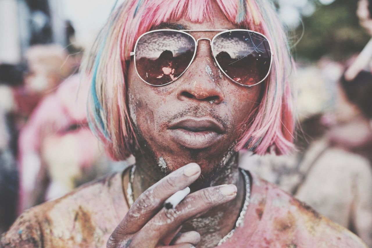 Close-up of man wearing sunglasses smoking cigarette