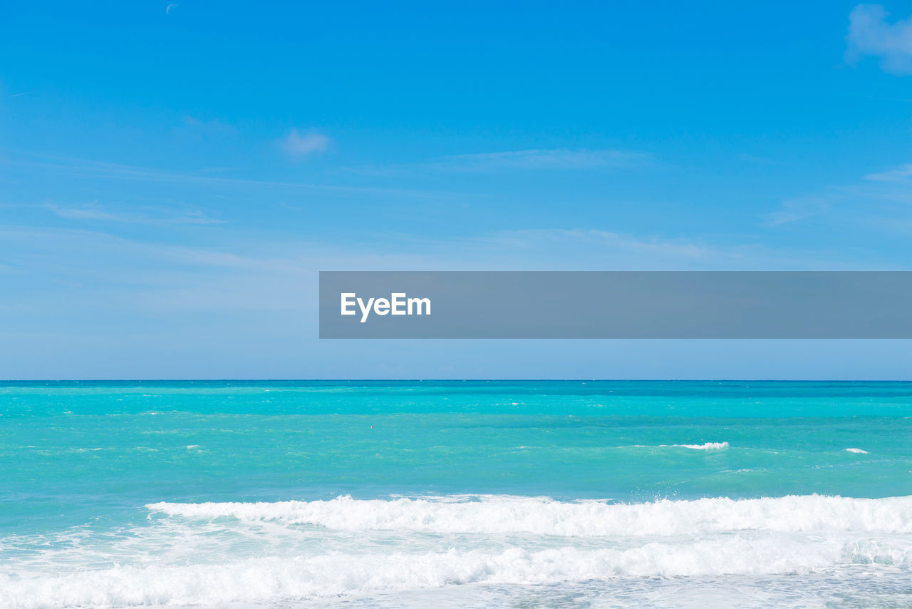 Scenic view of sea against blue sky