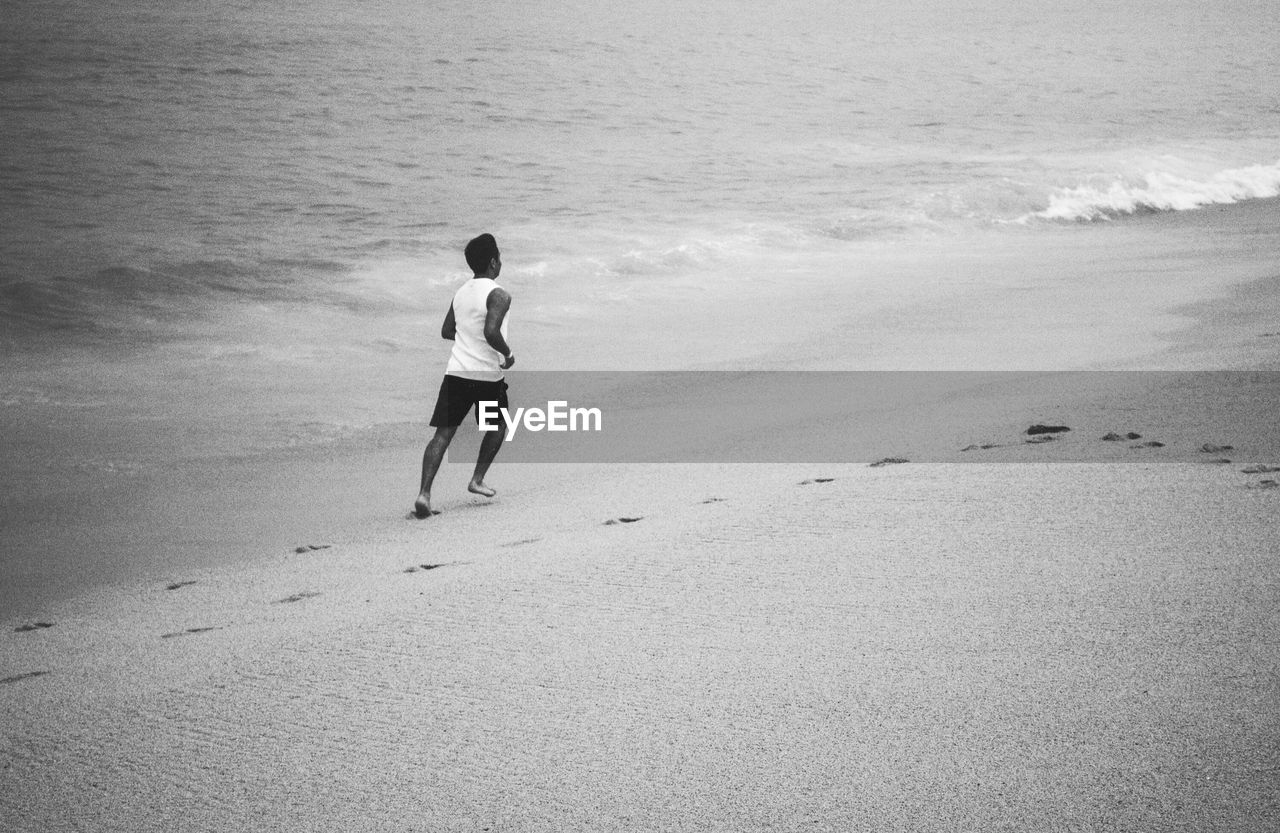 Full length of man running at beach