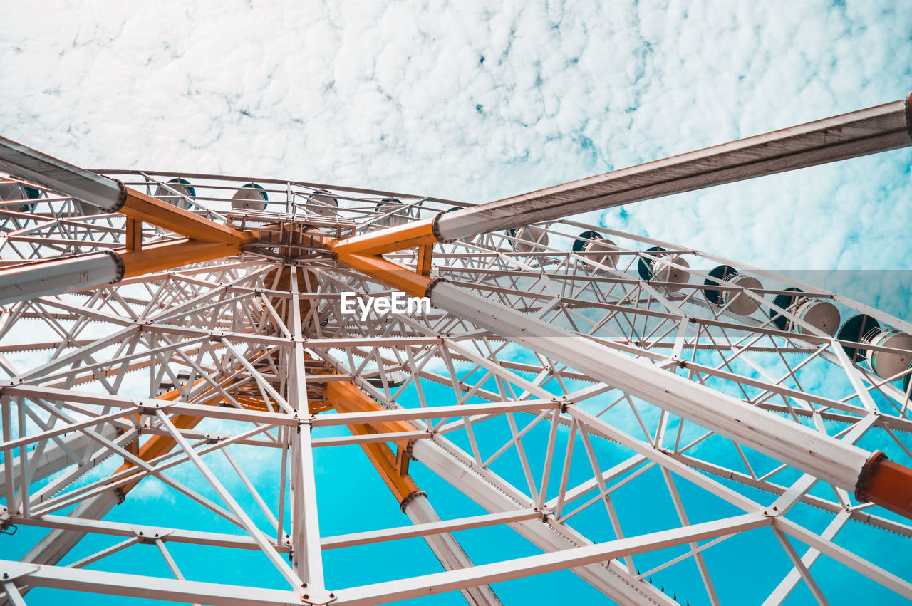 Close-up view of ferris wheel against sky 