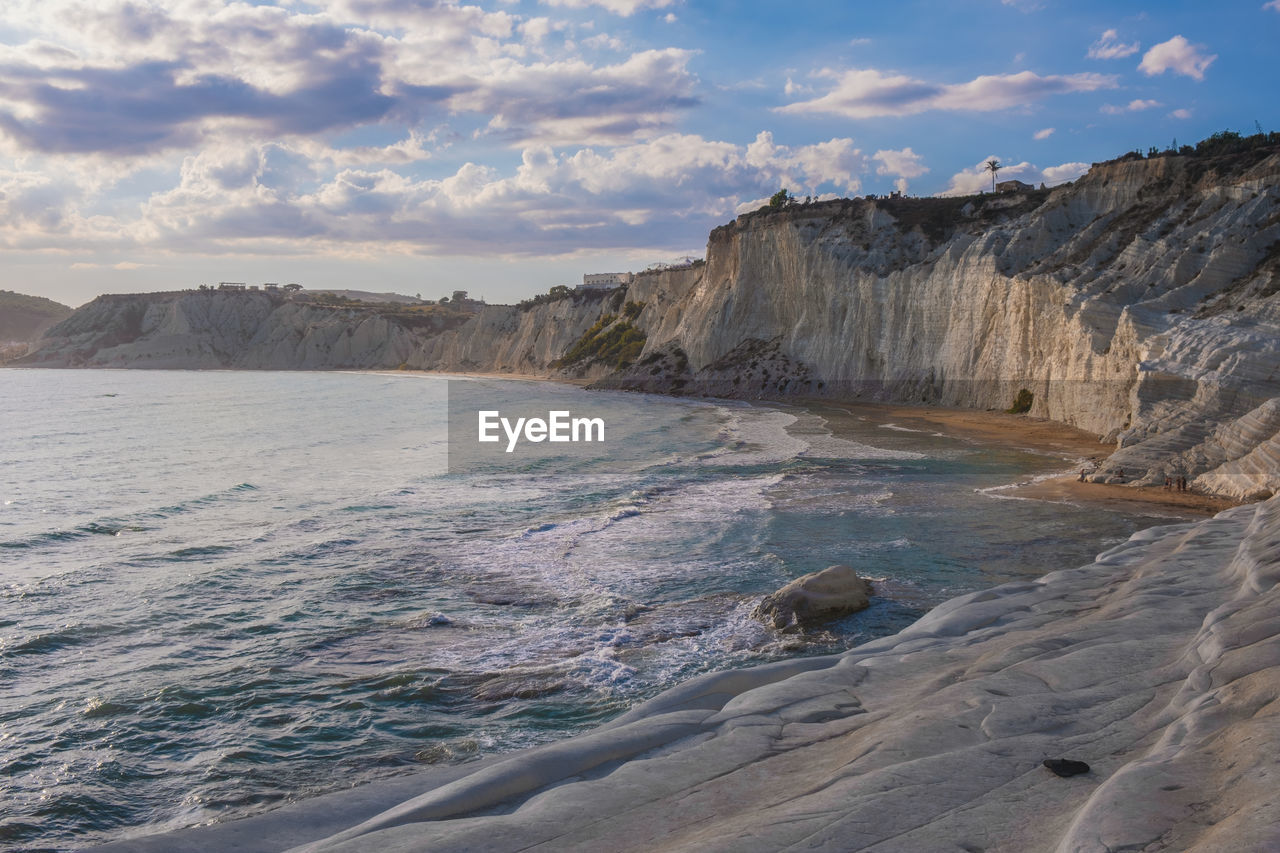 Scenic view of sea and mountains against sky