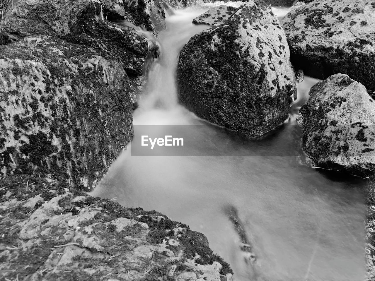 rock, water, black and white, nature, beauty in nature, waterfall, monochrome photography, scenics - nature, no people, monochrome, motion, land, stream, day, high angle view, environment, outdoors, river, rock formation, long exposure, water feature, non-urban scene, rapid, geology, tranquility, flowing water, landscape, flowing