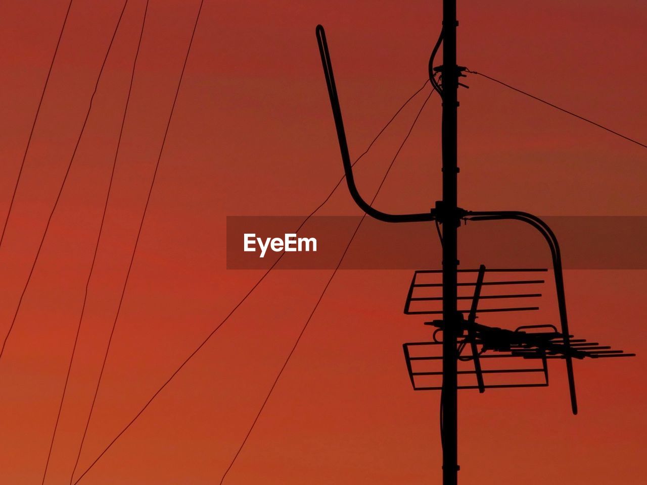 LOW ANGLE VIEW OF SILHOUETTE ELECTRICITY PYLON AGAINST SKY